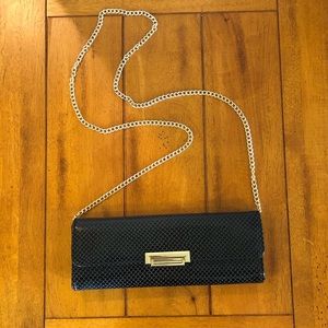 Small black handbag with a gold chain
